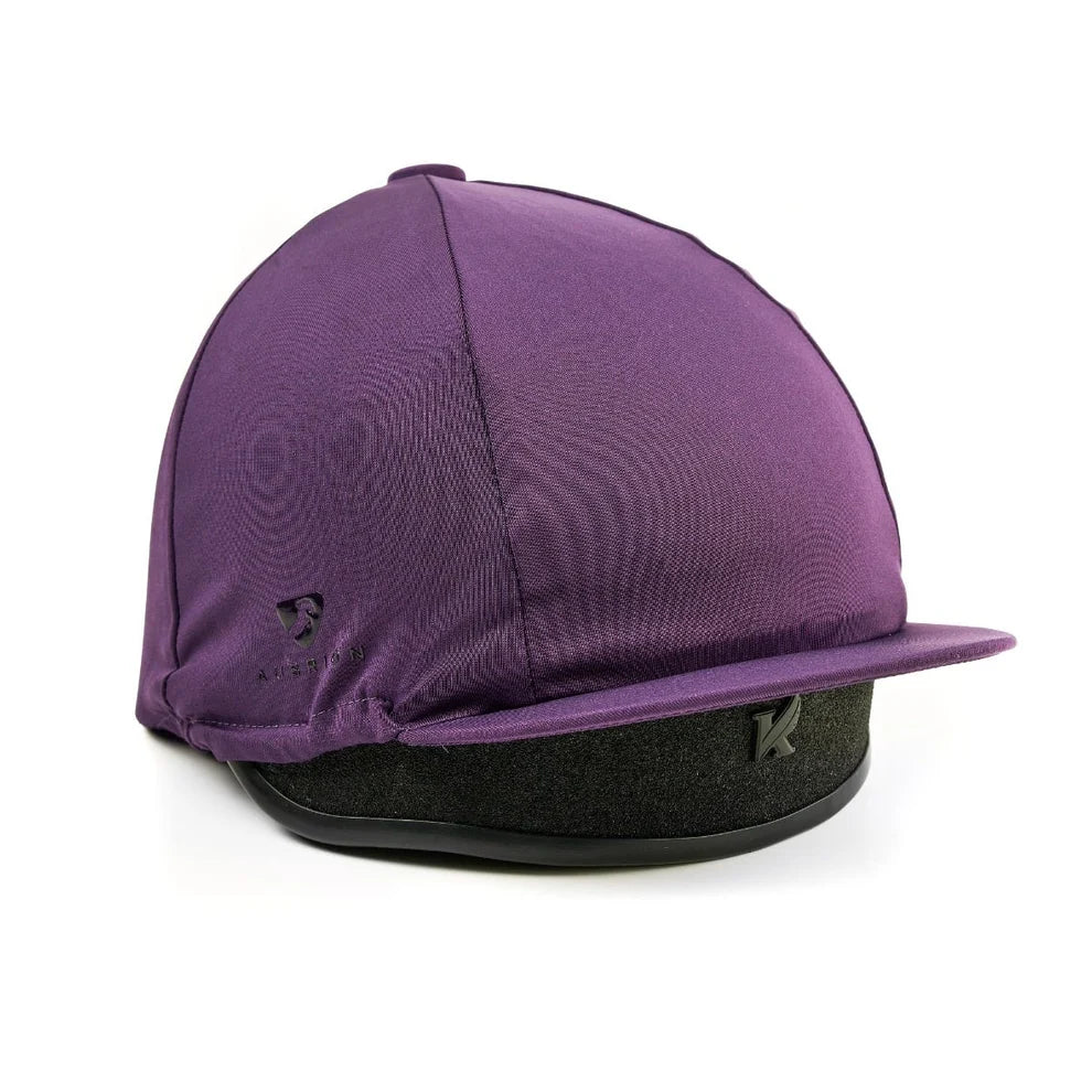 Purple equestrian helmet with black chin strap on a white background