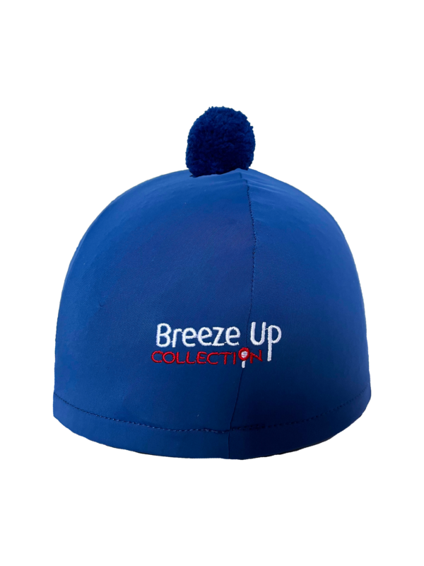Blue hat silk with pom-pom and 'Breeze Up Collective' logo on a white background