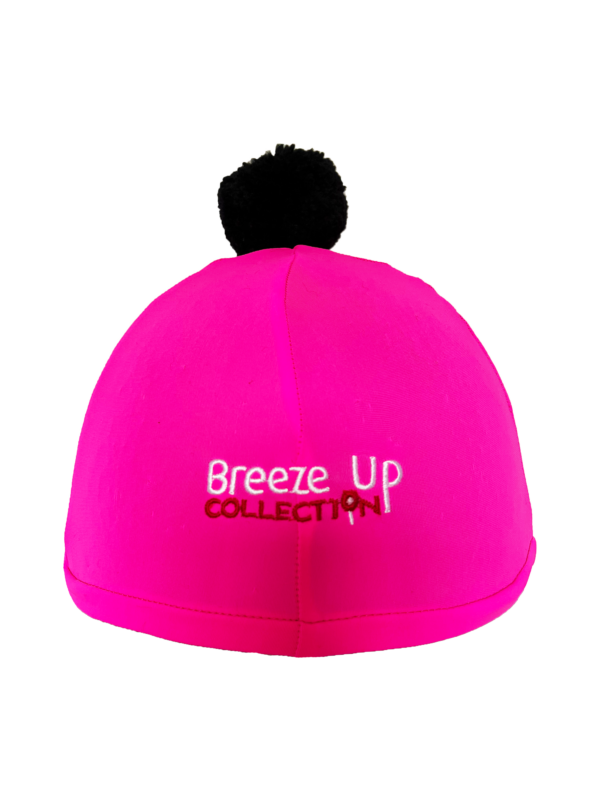 Pink helmet with black pom-pom and 'Breeze Up Collection' text on a white background