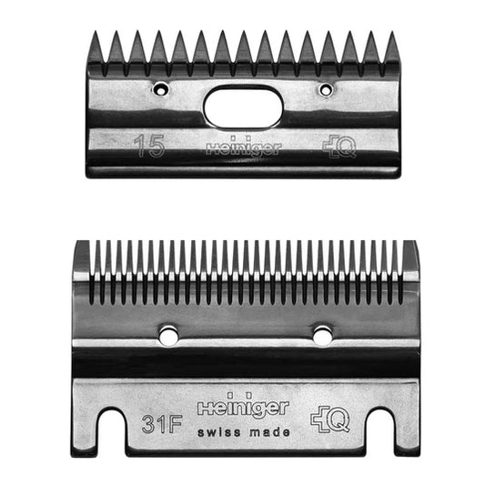 Two Heiniger hair clipper blades on a white background