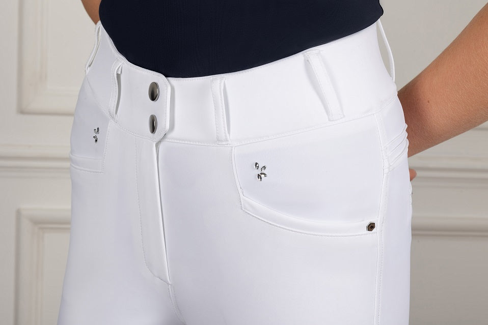 White pants with silver buttons and details on a neutral background