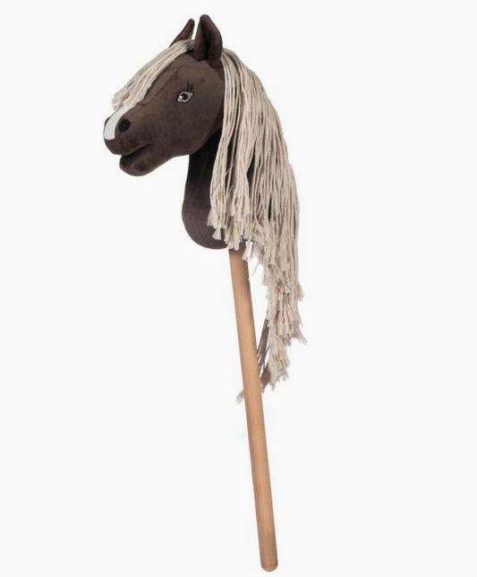 Horse head with a long mane on a wooden stick against a white background