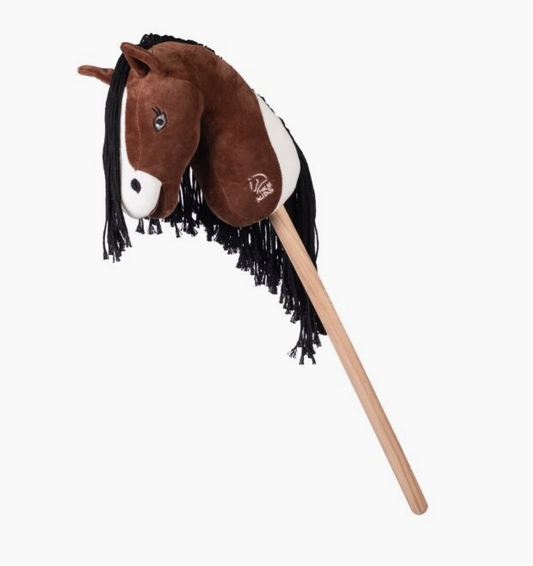 Plush horse head with a wooden stick on a white background