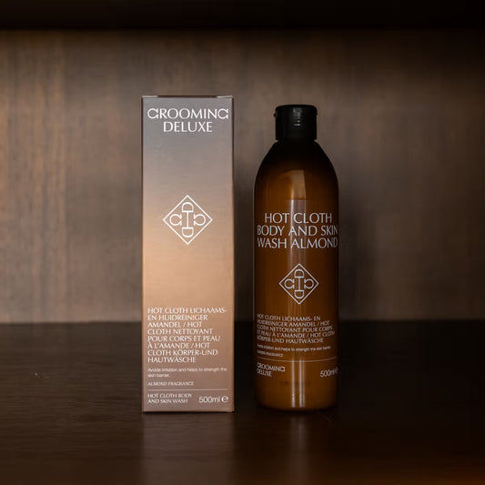 Grooming Deluxe hot cloth body and skin wash almond bottle and packaging on a wooden background