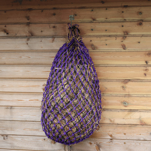 Purple haynet hanging on a wooden wall