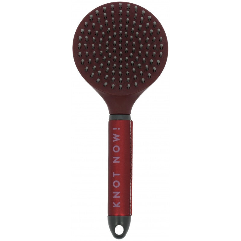 A round pet grooming brush with a dark reddish-brown silicone bristle head and a matching handle, featuring the brand name 'KNOT NOW!' printed vertically in white. The brush is shown against a plain white background.