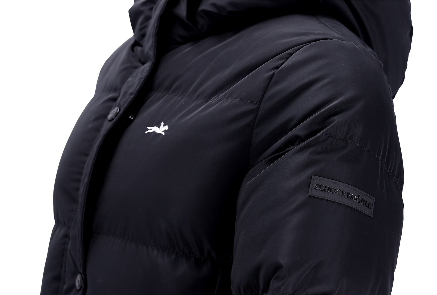 Close-up of a black hooded puffer jacket with a small white logo on the chest and a black rectangular brand patch on the sleeve, shown against a white background.