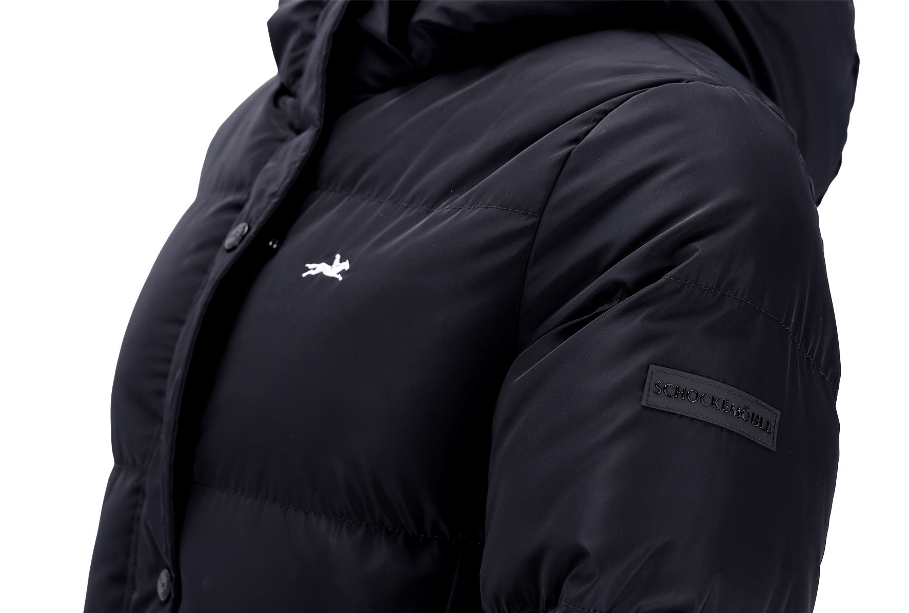 Close-up of a black hooded puffer jacket with a small white logo on the chest and a black rectangular brand patch on the sleeve, shown against a white background.