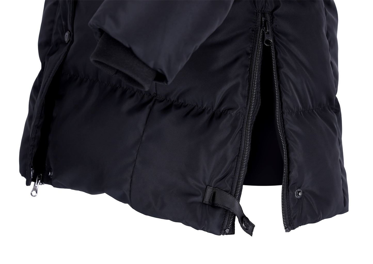 Close-up of a black puffer jacket showing the quilted fabric texture, a black zipper, and a black elastic strap detail on a white background.
