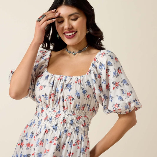 Woman wearing a floral dress against a beige background