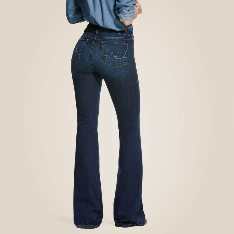 Person wearing blue jeans on a beige background