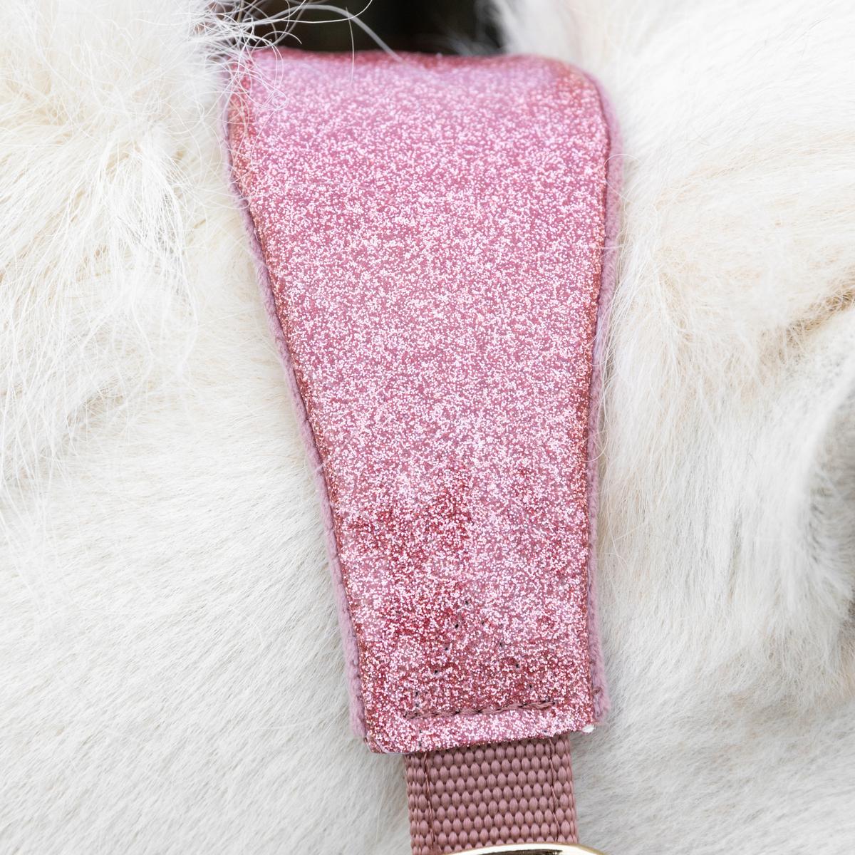 Pink glittery leg warm on a white furry surface