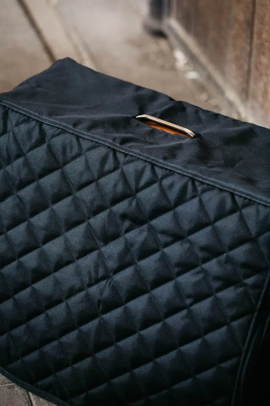 black cover on a wooden box in a stable yard