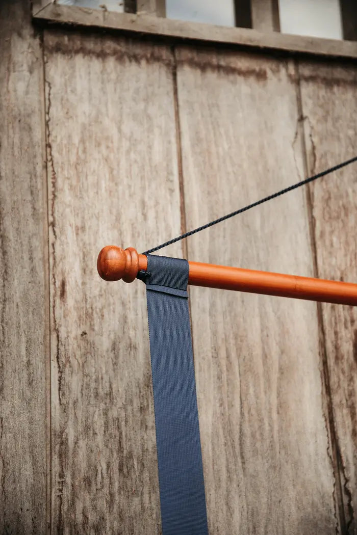 close up of a navy saddle pad holder in a barn