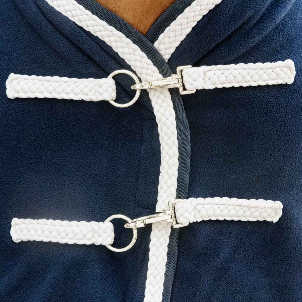 Navy blue horse rug front buckles with white corduroy on a horse