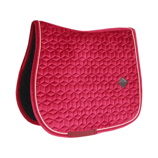 Red quilted saddle pad with a diamond pattern on a white background