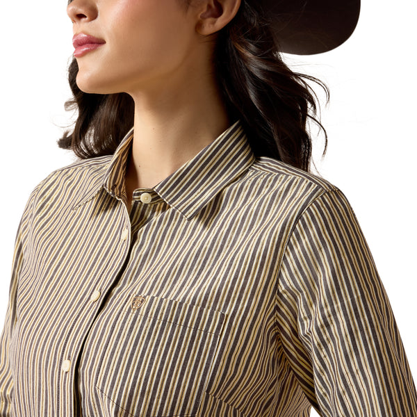 Close-up of a person wearing a striped shirt with a brand logo on a white background