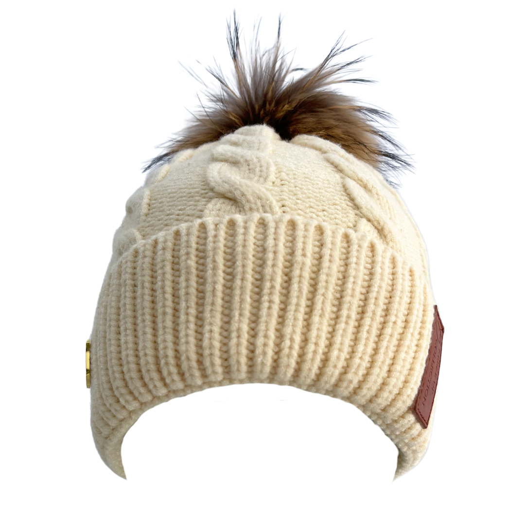 Beige knit beanie with a brown faux fur pom-pom on a white background