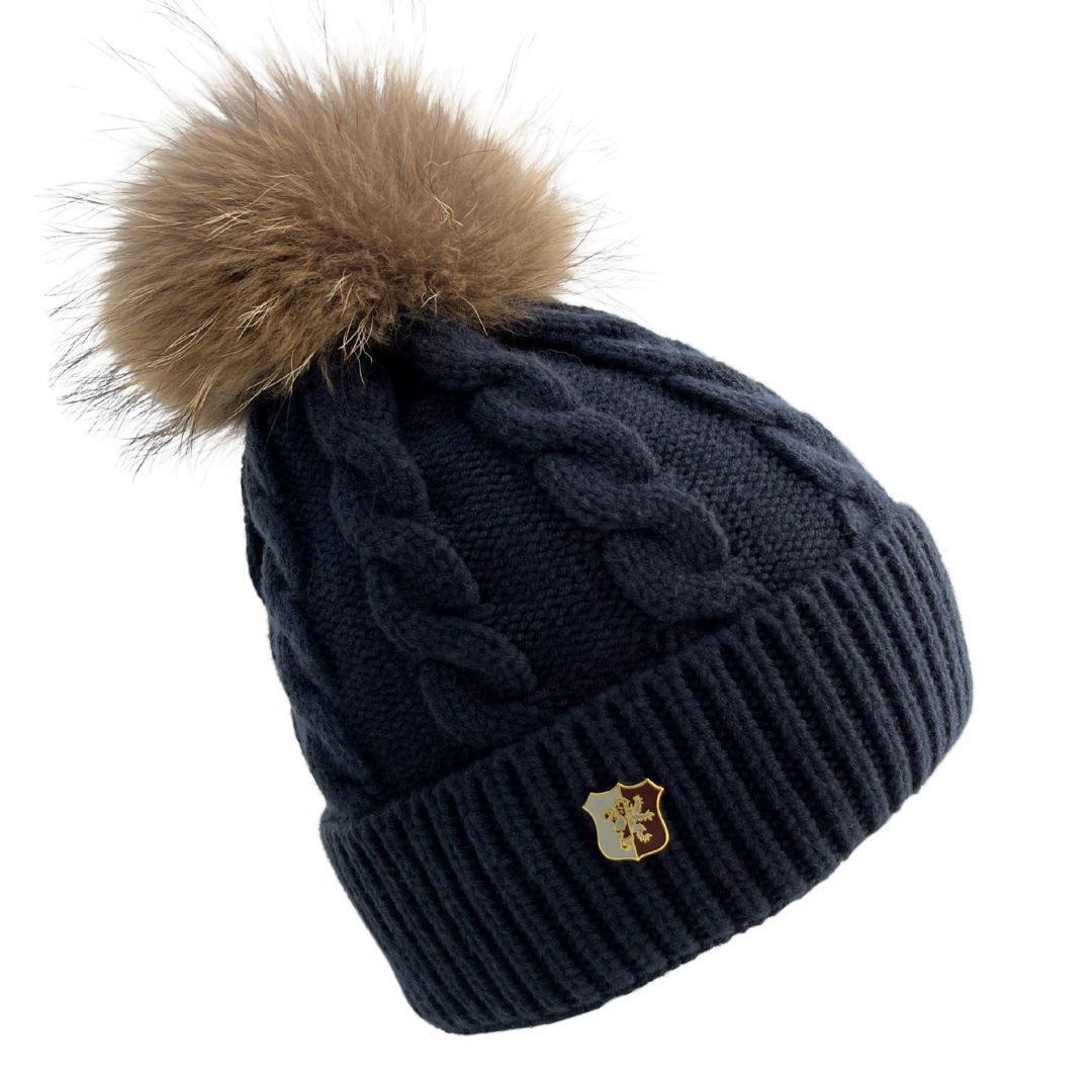 Navy blue knit beanie with brown fur pom-pom on a white background