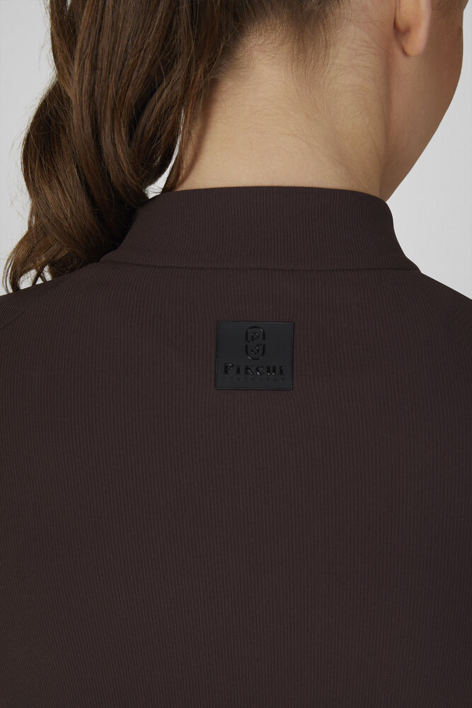 Close-up back view of a person wearing a dark brown ribbed knit top or sweater, showing a small black square brand patch on the upper back with the text 'FICMA'.