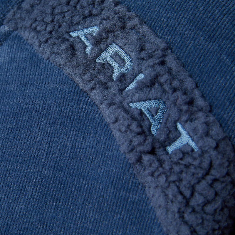 Close-up of a blue fleece jacket with 'Ariat' branding.