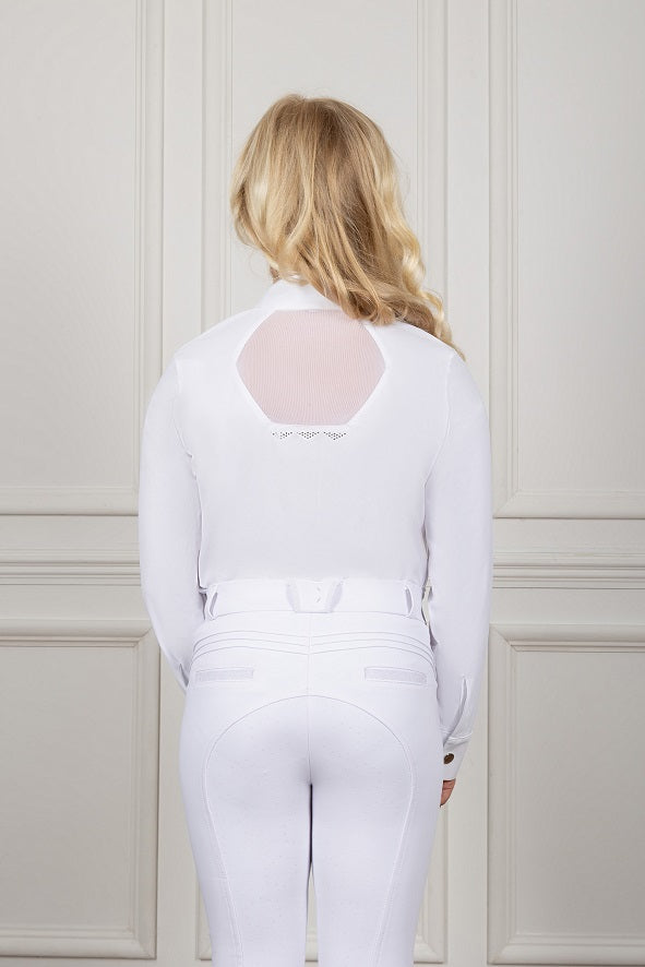 Person wearing a white outfit with sheer back design against a light-colored wall.