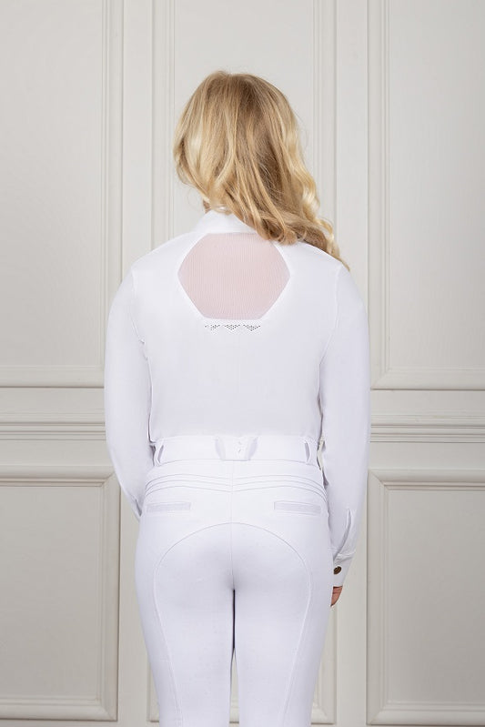 Person wearing a white outfit with sheer back design against a light-colored wall.