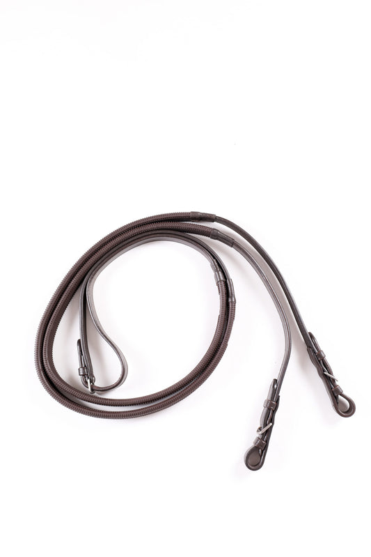 Pair of brown leather reins on a white background