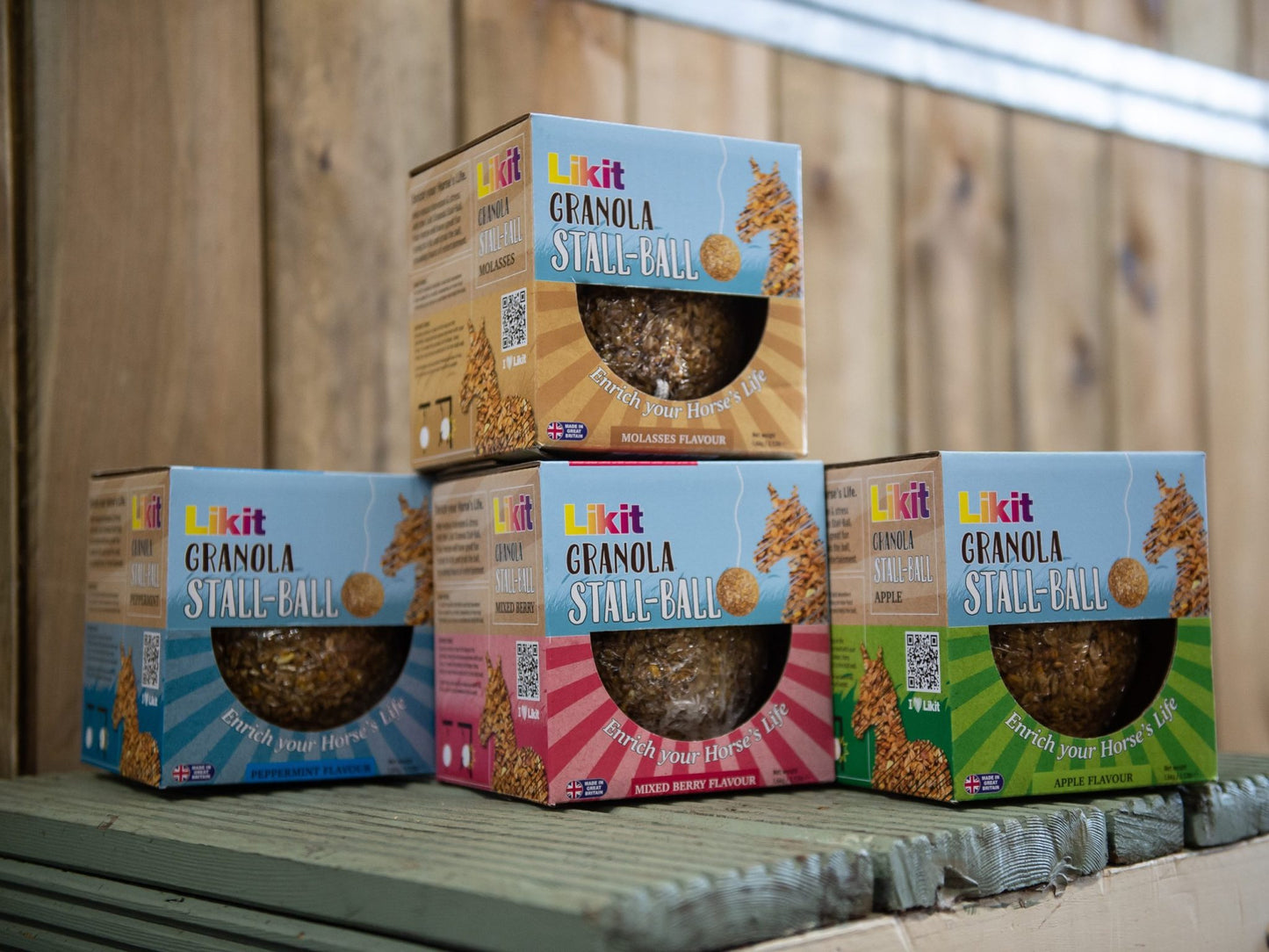 Stack of Likit Granola Stale Ball boxes on a wooden surface