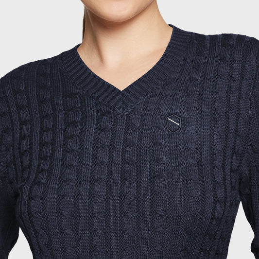 Navy blue cable knit sweater with a brand logo on a light gray background