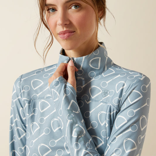 Woman wearing a blue patterned shirt against a beige background