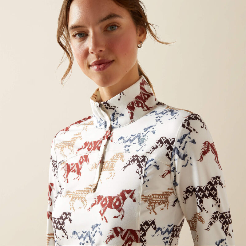 Woman wearing a white shirt with horse pattern on a beige background