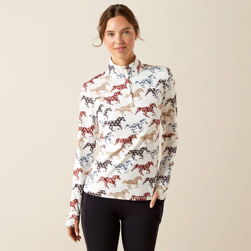 Woman wearing a patterned long-sleeve shirt with horses on a beige background