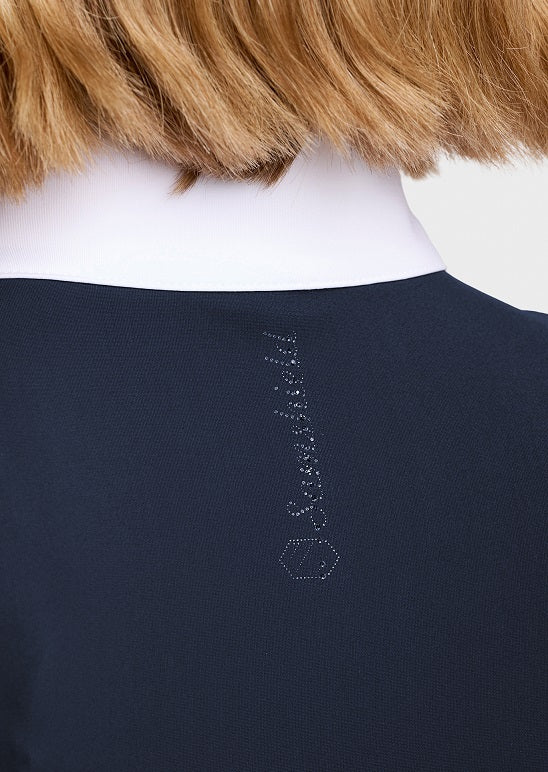 Close-up back view of a dark navy top showing a small vertical embroidered brand detail and a hexagon logo near the lower back.