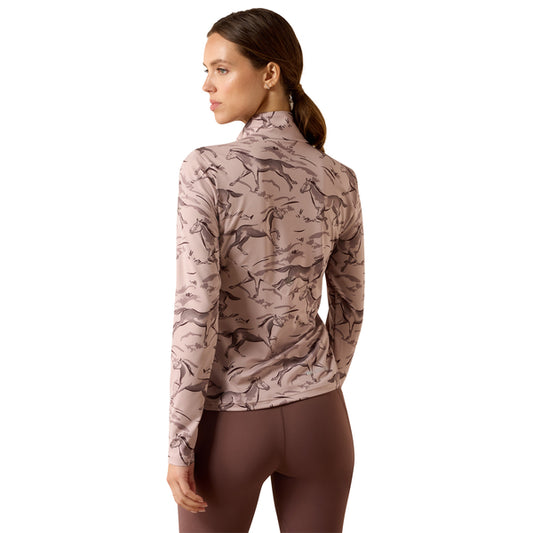 A woman shown from the back wearing a long-sleeve athletic top with a dusty pink and brown horse pattern, paired with brown leggings, against a solid white background.