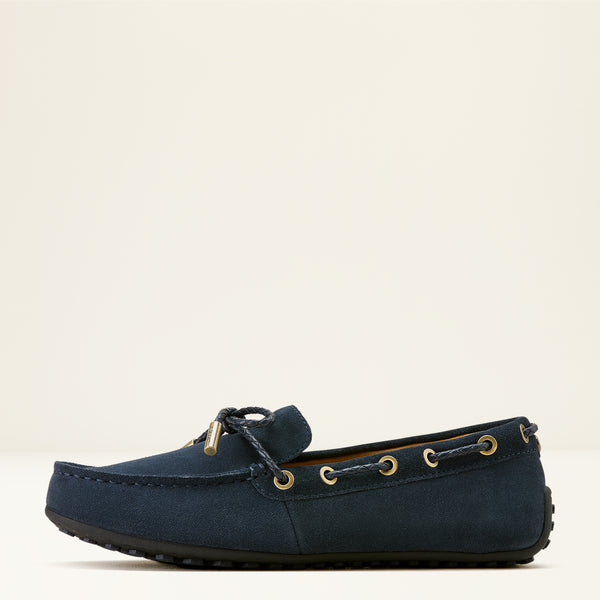 Navy blue loafer shoe on a beige background