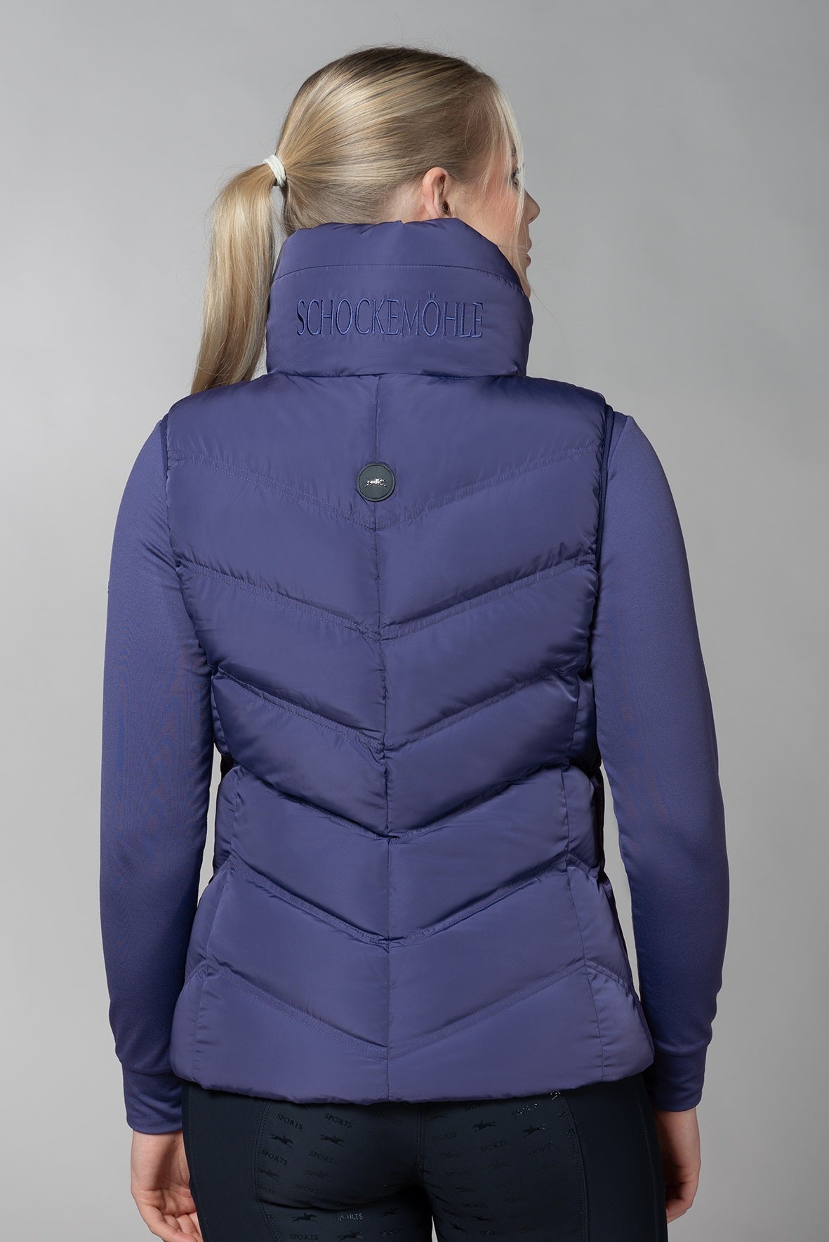 Ink Blue gilet back with Schockemohle writing and logo badge