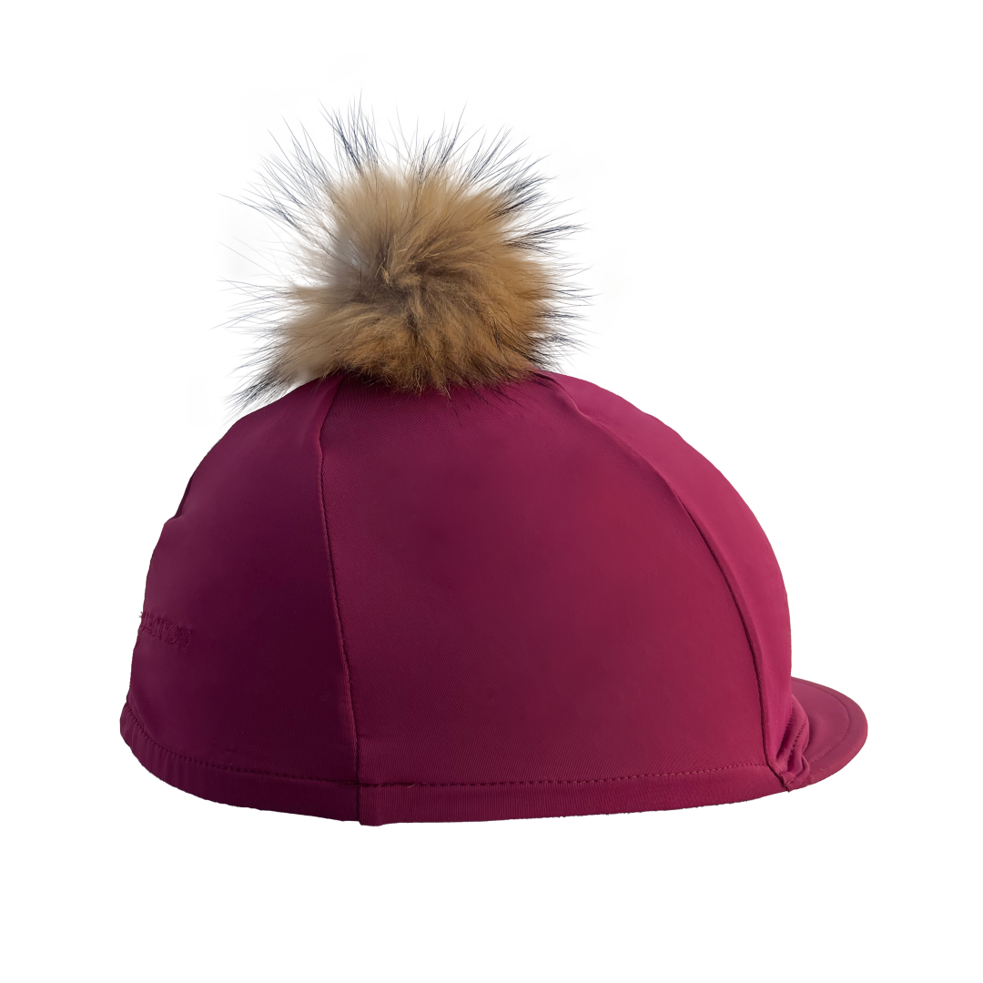 Maroon riding hat with a fur pom-pom on a white background