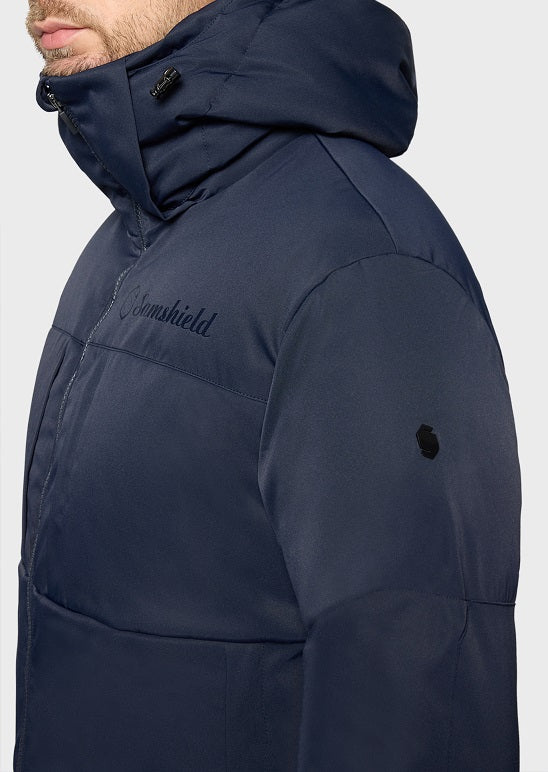 Close-up of a person wearing a dark navy hooded puffer jacket with a visible 'Cromshield' logo on the chest, against a light gray background.