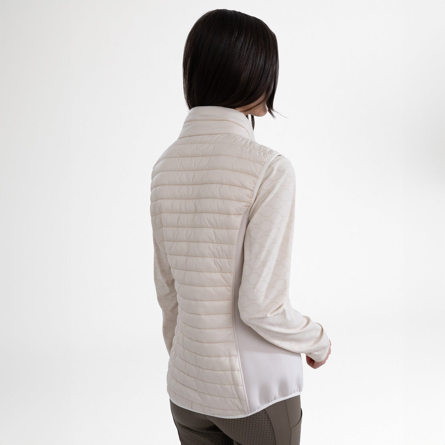Girl wearing a cream gilet and brown breeches on a white background