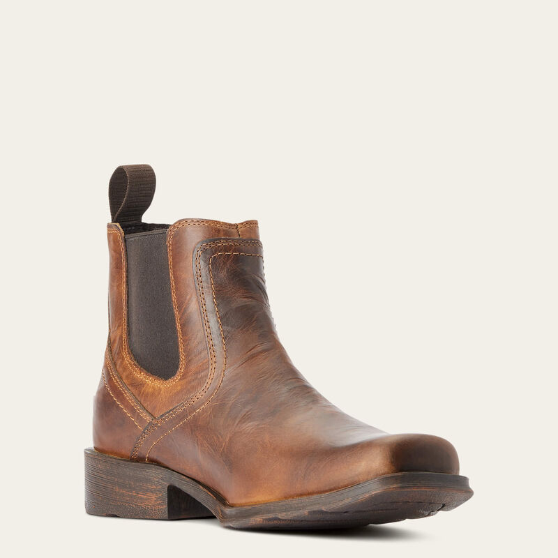Brown leather boot on a light beige background