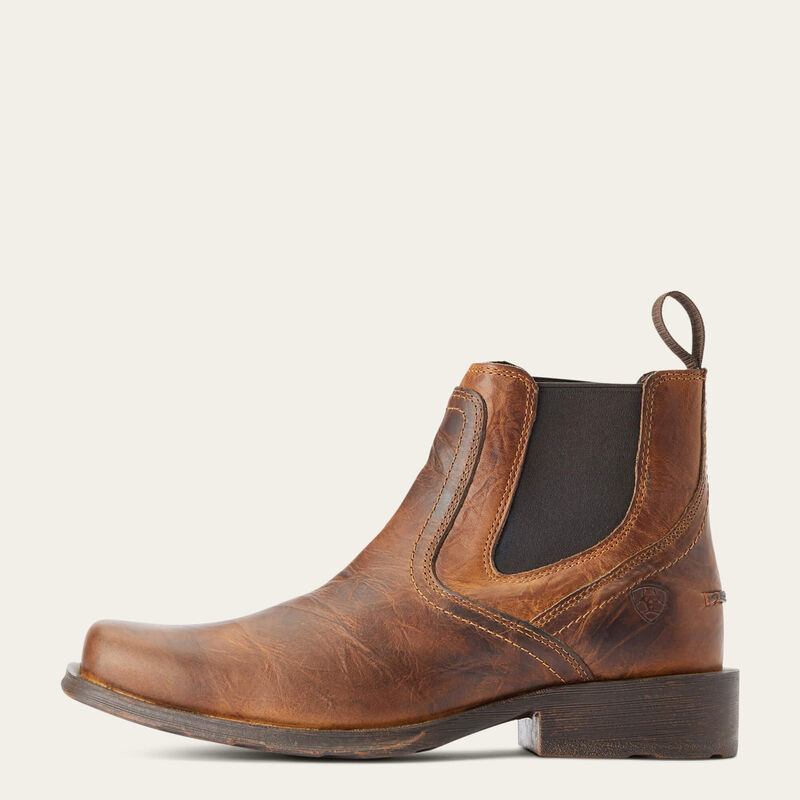 Brown leather boot with a white background