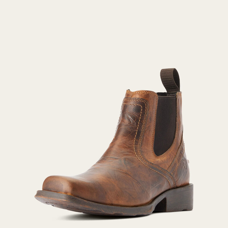 Brown leather boot with a black sole on a white background