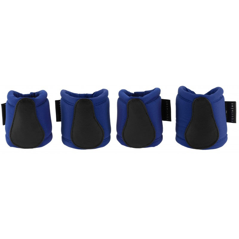 Four blue and black protective gear pads on a white background