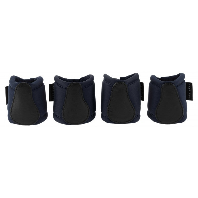 Four navy protective horse boots on a white background