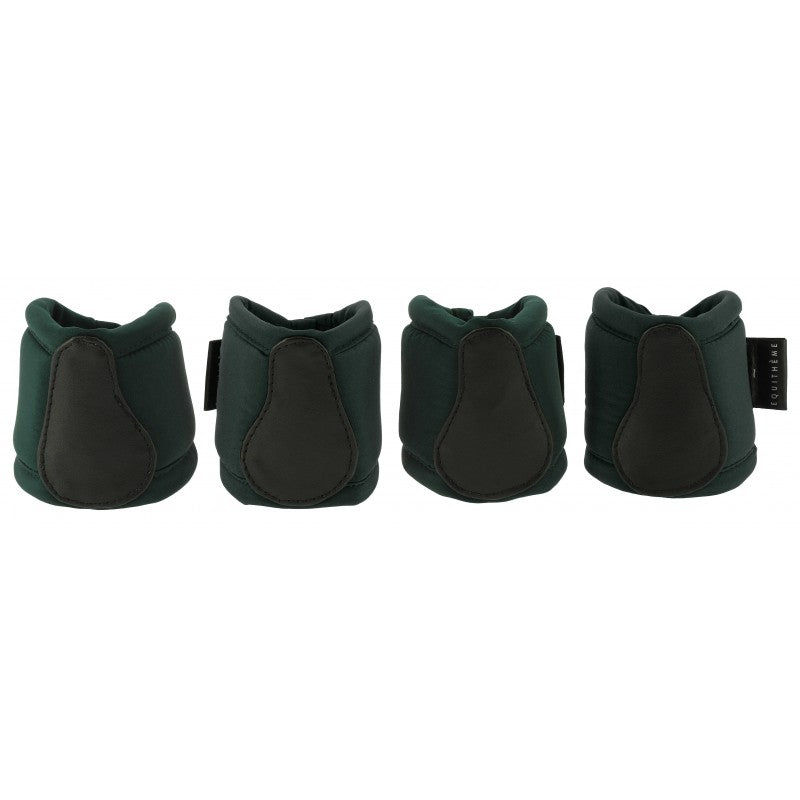 Four green and black protective boot covers on a white background