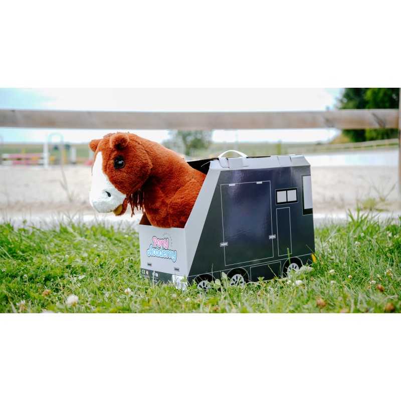 Stuffed horse toy inside a toy truck on grass with a white background