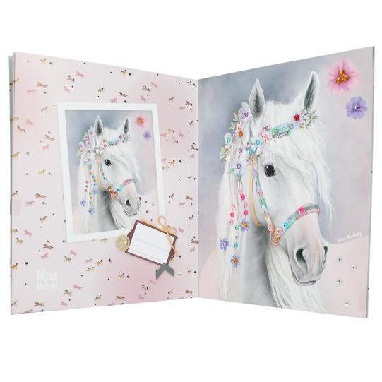 Page of a diamond stickerbook with a white horse and a floral bridle.