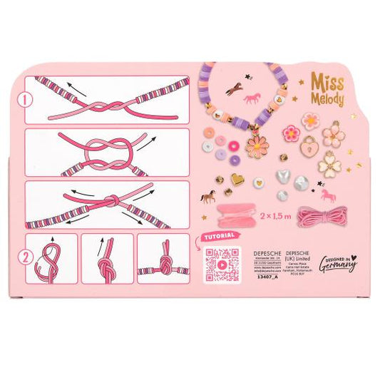 Pink packaging of a bead set kit with tutorials and decorative items on a white background.
