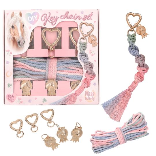 Key chain set with pink and blue braided cord, gold charms, and packaging on a white background